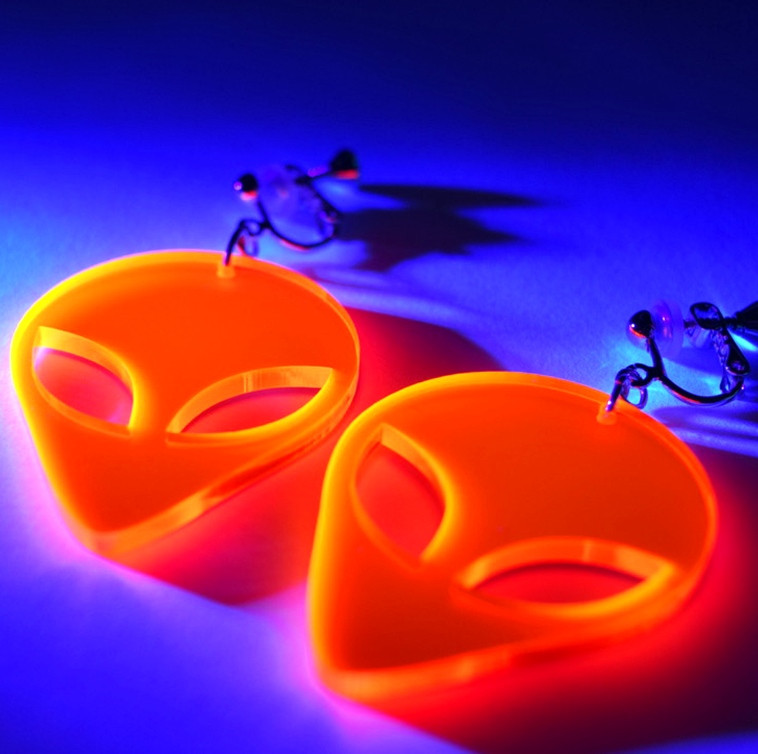 red / orange alien clip on earrings glowing in uv / blacklight - part oof the Pyromaniax launch collection